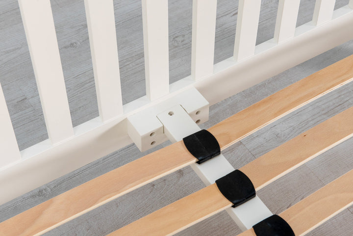 Close-up of sprung wooden slats and centre support rail on the Boston Soft White 5ft King Size bed frame.