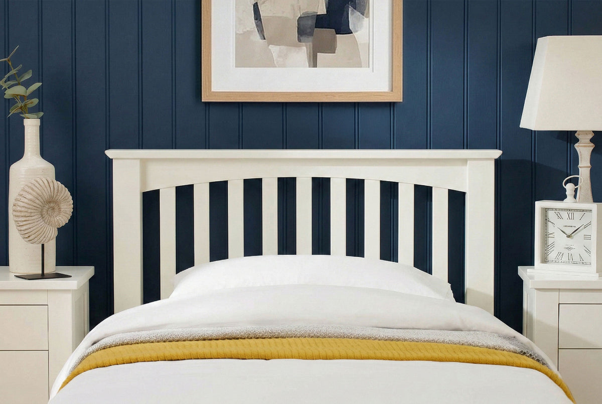 Close up of Boston Soft White Solid Wood 3ft Single Bed Frame headboard with white bedding and mustard throw