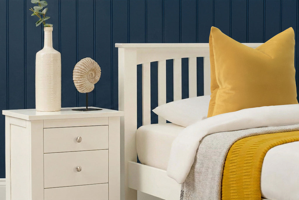 Detailed side view of Boston Soft White Solid Wood 3ft Single Bed Frame with yellow accent pillow and bedside table