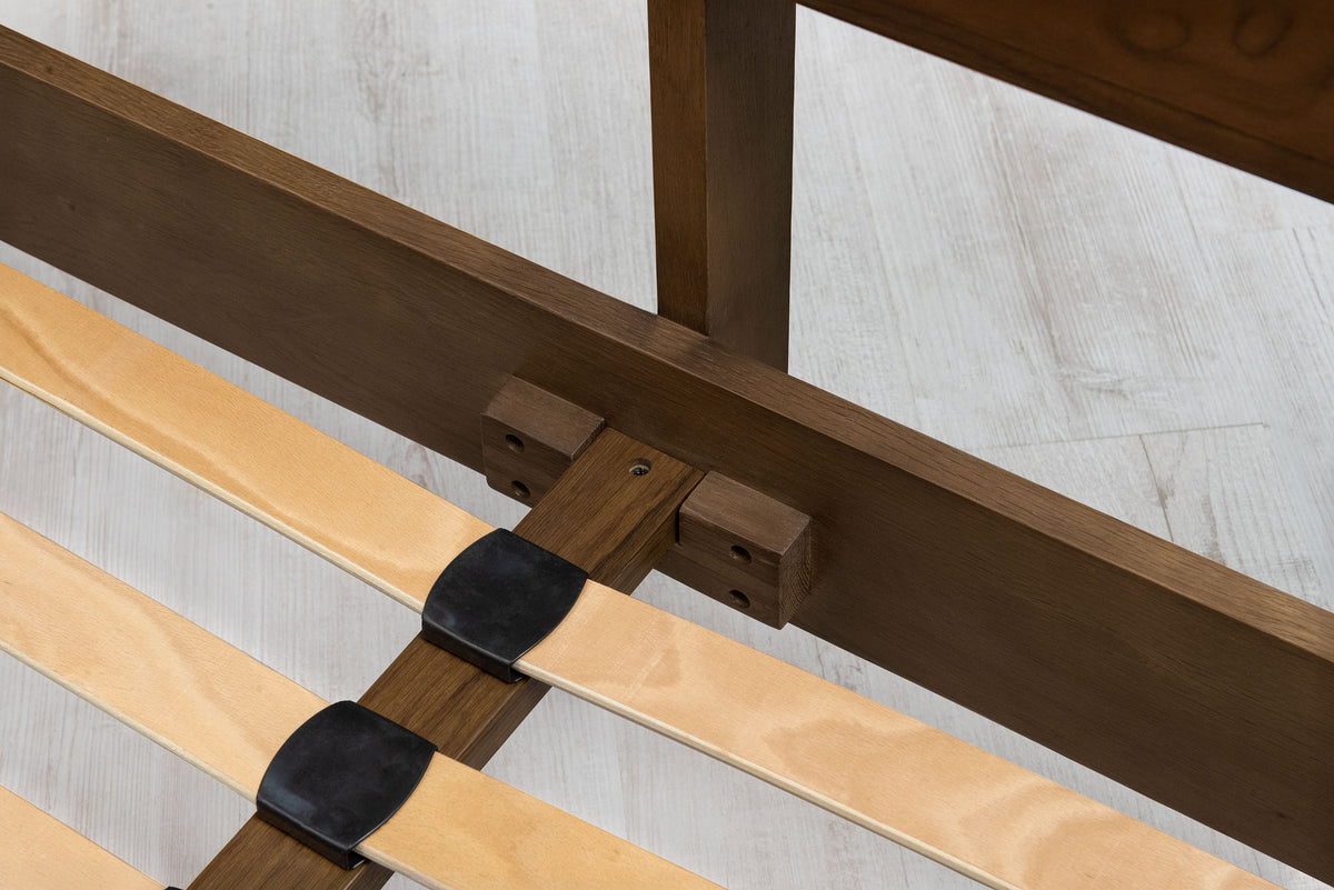 Mayfair solid walnut double bed centre rail close-up, fixed to the head-end rail with a solid oak support block