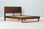 Mayfair solid walnut double bed frame with floating sled leg and no mattress, angled view showing the slatted base