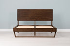 Mayfair solid walnut double bed frame with floating sled leg and no mattress, front view from the foot of the bed