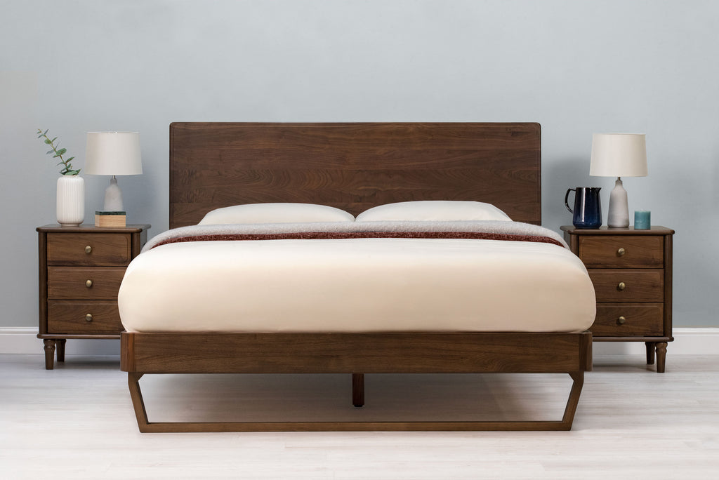 Mayfair solid walnut double bed frame with floating sled leg, front view without scatter cushions, showing the headboard