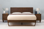 Mayfair solid walnut double bed frame with floating sled leg, front view without scatter cushions, showing the headboard