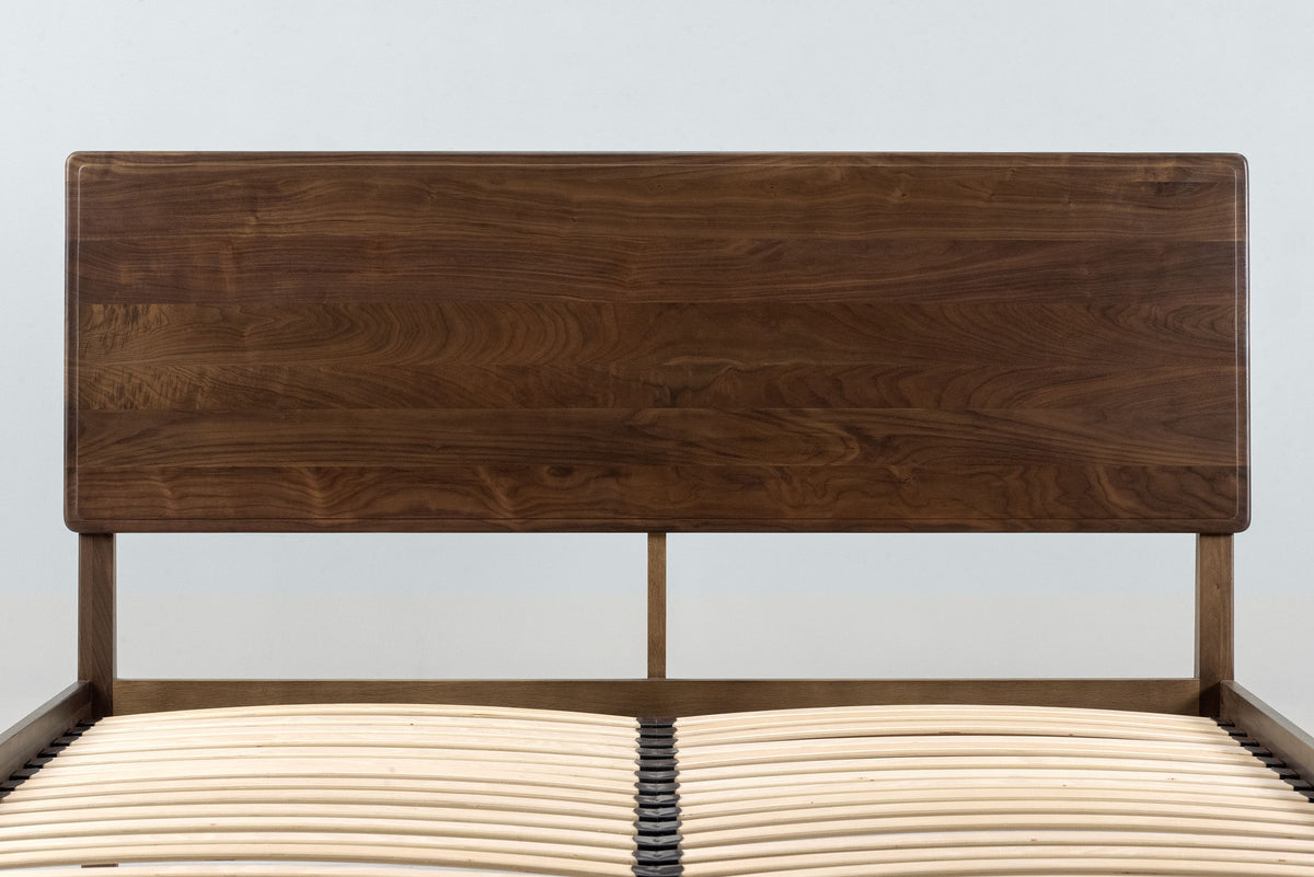 Mayfair solid walnut double bed headboard and sprung slatted base without a mattress, front close-up