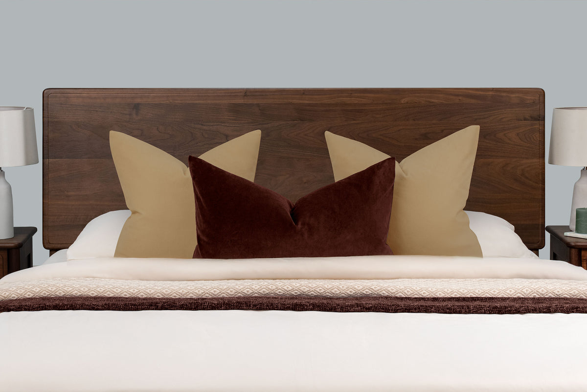 Mayfair solid walnut double bed headboard, front close-up with tan and burgundy scatter cushions