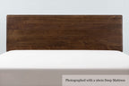 Mayfair solid walnut double bed headboard, front close-up with a 26cm deep mattress and no bedding