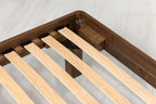 Mayfair solid walnut double bed frame corner close-up, showing the steel corner bracket, corner block and sprung slats