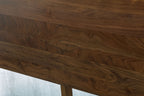 Mayfair solid walnut double bed headboard close-up, showing the natural grain and figuring of the solid walnut