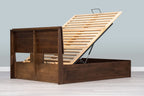 Mayfair solid walnut double ottoman bed frame from behind with the slatted base raised, showing the back of the headboard