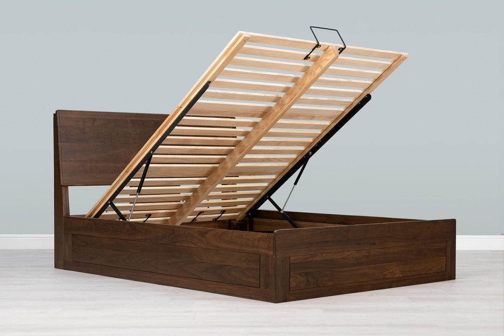 Mayfair solid walnut double ottoman bed frame without a mattress, with the slatted base raised on gas-lift struts