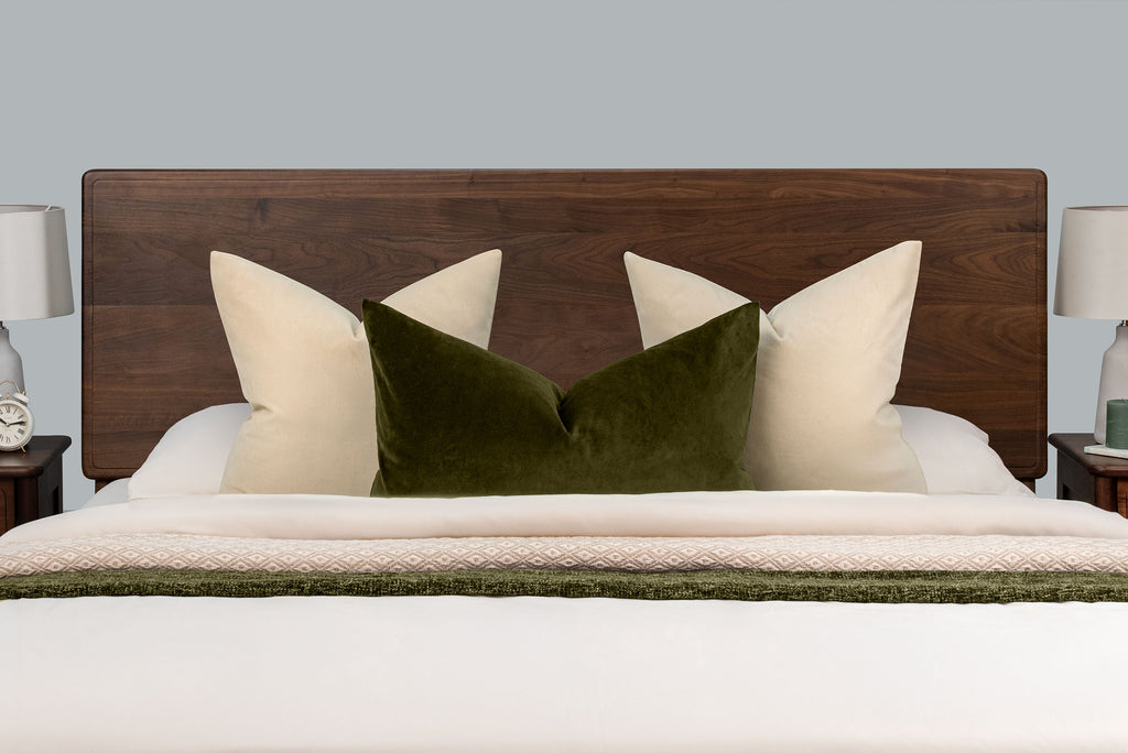 Mayfair solid walnut double ottoman bed headboard, front close-up with cream and green scatter cushions