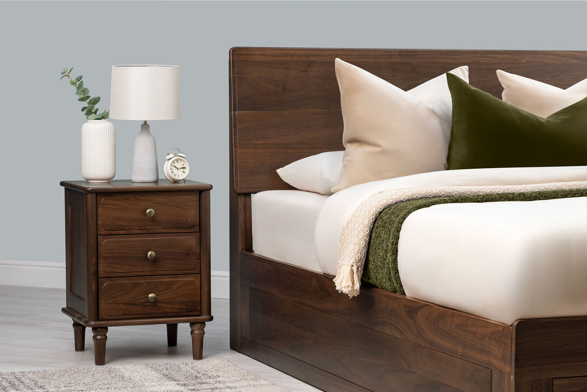 Mayfair solid walnut king size ottoman bed headboard with cream and green bedding and a matching three-drawer bedside table