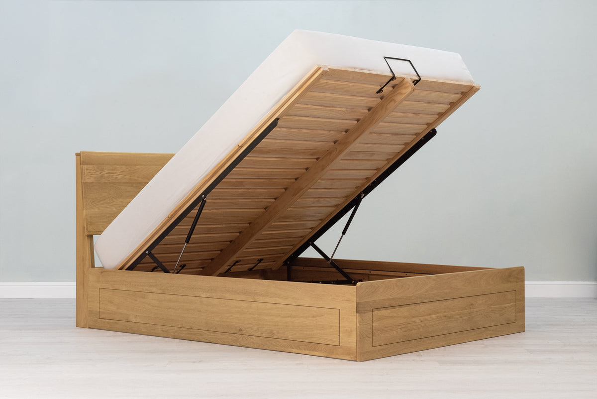 Mayfair Solid Natural Oak Ottoman Storage Bed Frame 6ft Super King, side angle view with the ottoman base lifted and the mattress in place