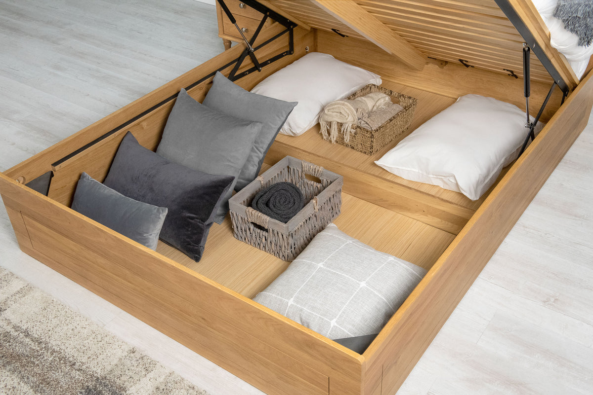 Mayfair Solid Natural Oak Ottoman Storage Bed Frame 6ft Super King, under-bed storage area holding pillows, cushions and baskets with the ottoman base raised