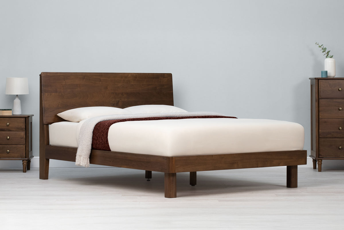 Mayfair solid walnut super king bed frame with square legs, angled view without scatter cushions, showing the panel headboard