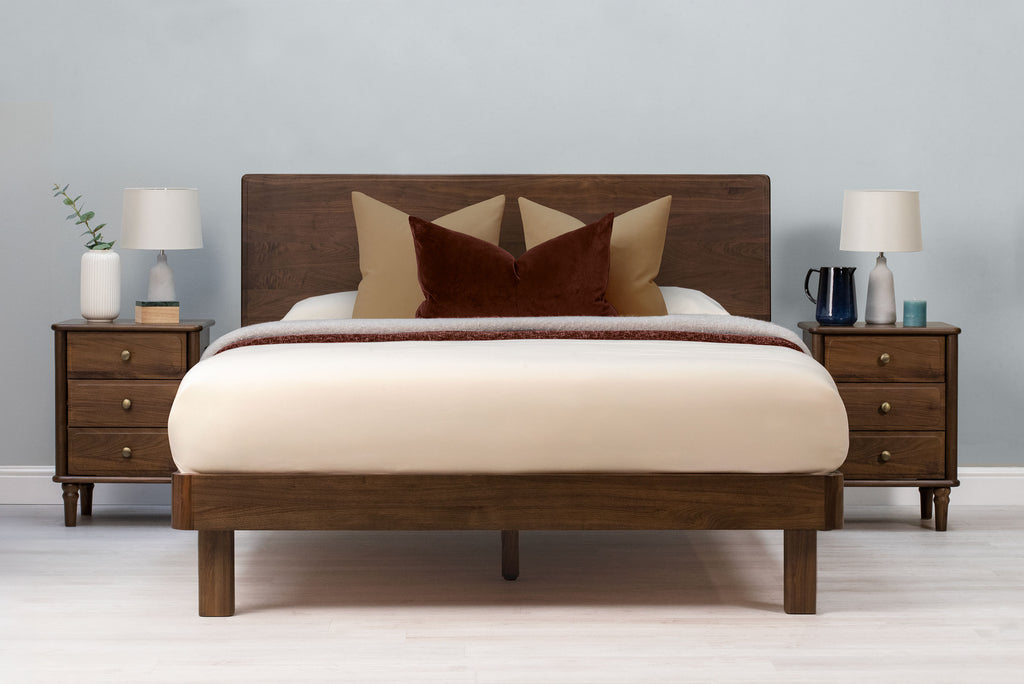 Mayfair solid walnut super king bed frame with square legs, front view from the foot of the bed with matching walnut bedside tables