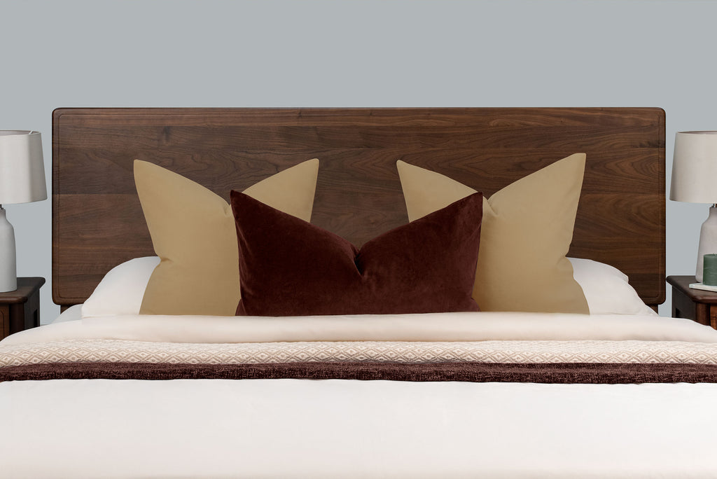 Mayfair solid walnut super king bed headboard, front close-up with tan and burgundy scatter cushions