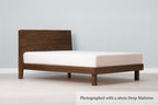 Mayfair solid walnut super king bed frame with square legs, a 26cm deep mattress and no bedding, angled view