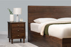 Mayfair solid walnut super king ottoman bed headboard with plain white pillows, beside a matching three-drawer bedside table