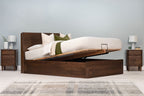 Mayfair solid walnut super king ottoman bed frame with the mattress base partially raised to open the under-bed storage