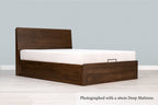 Mayfair solid walnut super king ottoman bed frame with a 26cm deep mattress and no bedding, angled view