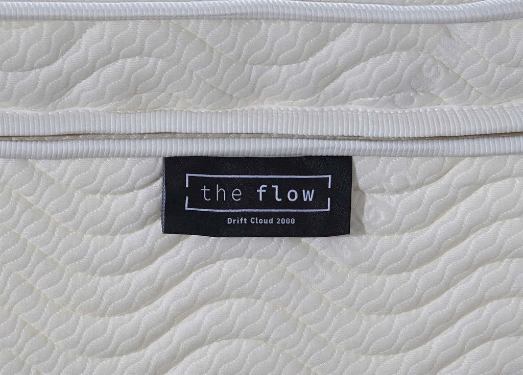 The Flow Drift Cloud 2000 mattress brand label close up on quilted fabric side panel
