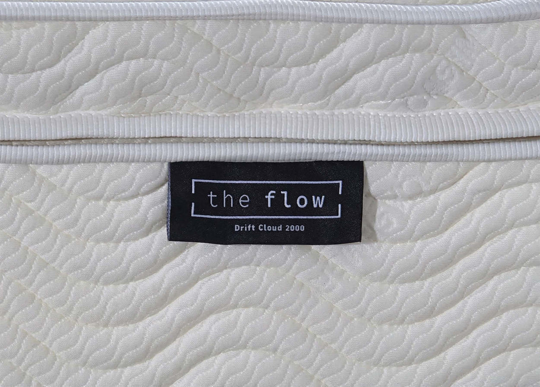 The Flow Drift Cloud 2000 mattress brand label close up on quilted fabric side panel