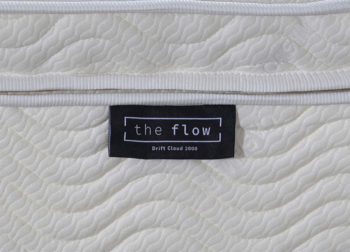 The Flow Drift Cloud 2000 mattress brand label close up on quilted fabric side panel