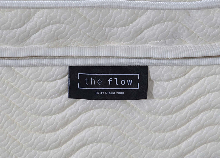 The Flow Drift Cloud 2000 mattress brand label close up on quilted fabric side panel