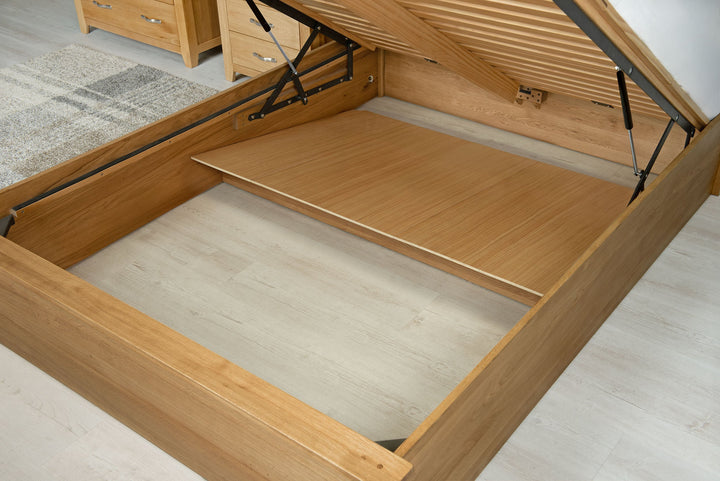 Wilmore solid natural oak double ottoman bed storage area with one removable plywood base panel in place