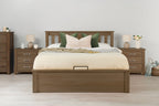 Wilmore solid rustic oak super king ottoman bed frame dressed with cream bedding and green cushions, front view with matching bedside tables