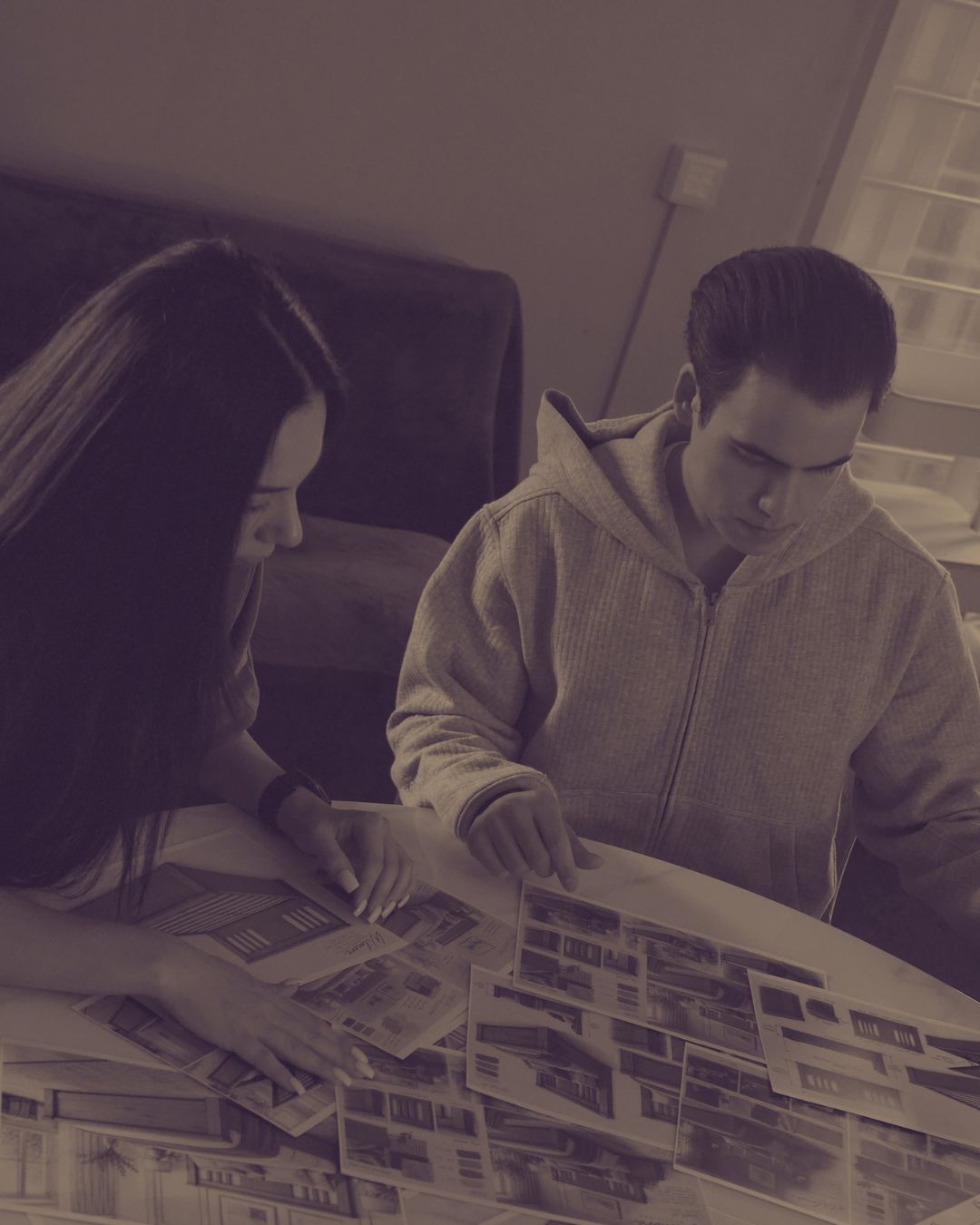 Two of the family going through bed designs together at a table